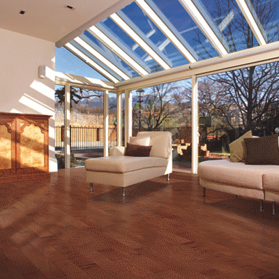 A room with glass walls and wood floors.