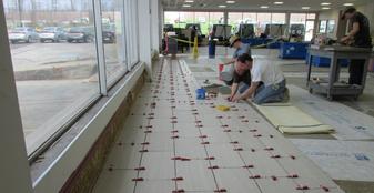 A group of people working on the floor in a room.