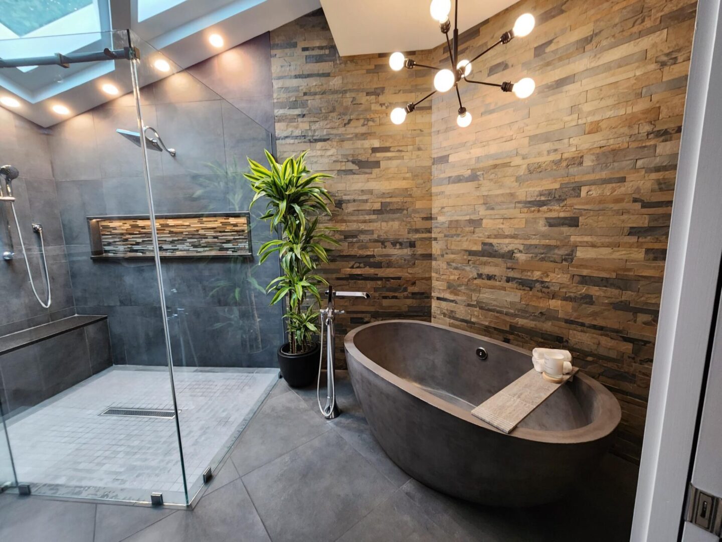 A bathroom with a tub, shower and plants.