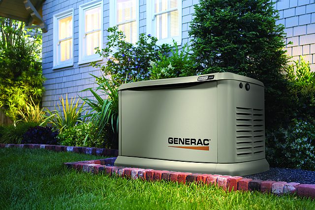 A home with a generator in the grass.